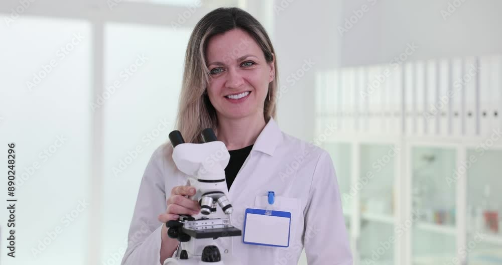 Laboratory worker shows modern microscope in hospital Laboratory worker shows modern microscope in hospital