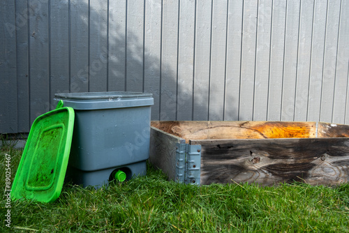 Bokashi bucket on the lawn with pallet for composting foodscraps to nutrient soil with bio char
