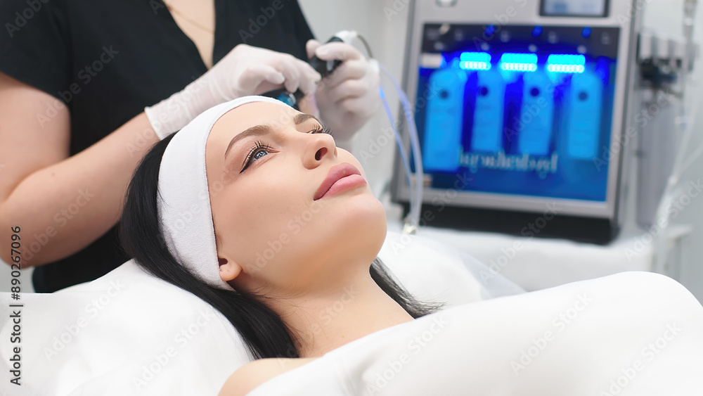 A cosmetologist prepares a device for modern facial cleansing. Modern cosmetology technologies. A cosmetologist prepares a device for modern facial cleansing. Modern cosmetology technologies.