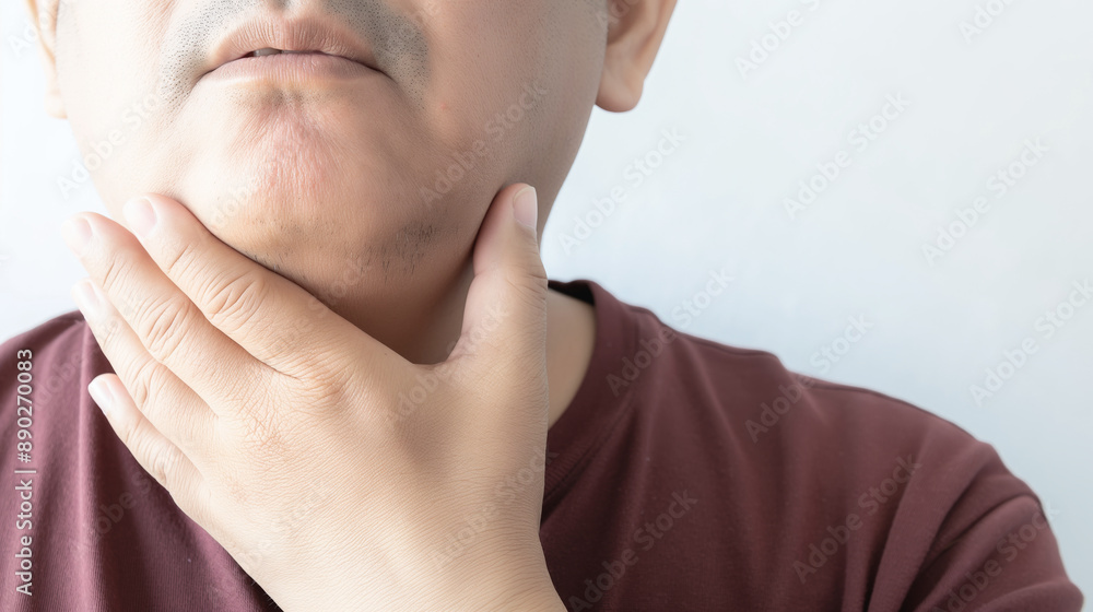 Man touching his neck with a concerned expression. Closeup view highlighting skin texture and hand detail