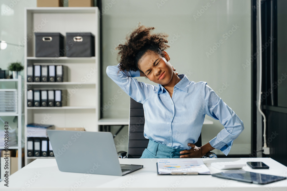 Overworked young businesswoman office worker suffering from neck pain after had a long day. office syndrome concept Overworked young businesswoman office worker suffering from neck pain after had a long day. office syndrome concept