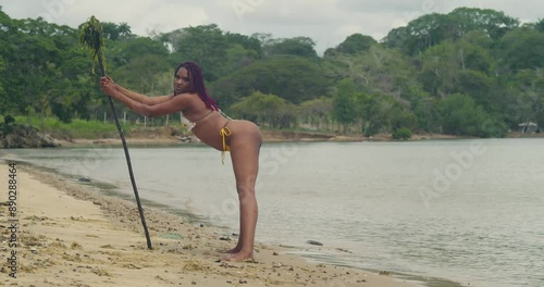 At a tropical Caribbean beach, a young girl in a bikini. photo