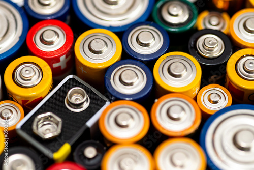 Fotografie Background made of various alkaline and lithium-ion batteries, positive pole visible