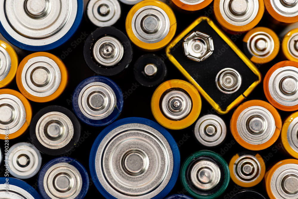 Background made of various alkaline and lithium-ion batteries, positive pole visible. Background made of various alkaline and lithium-ion batteries, positive pole visible.