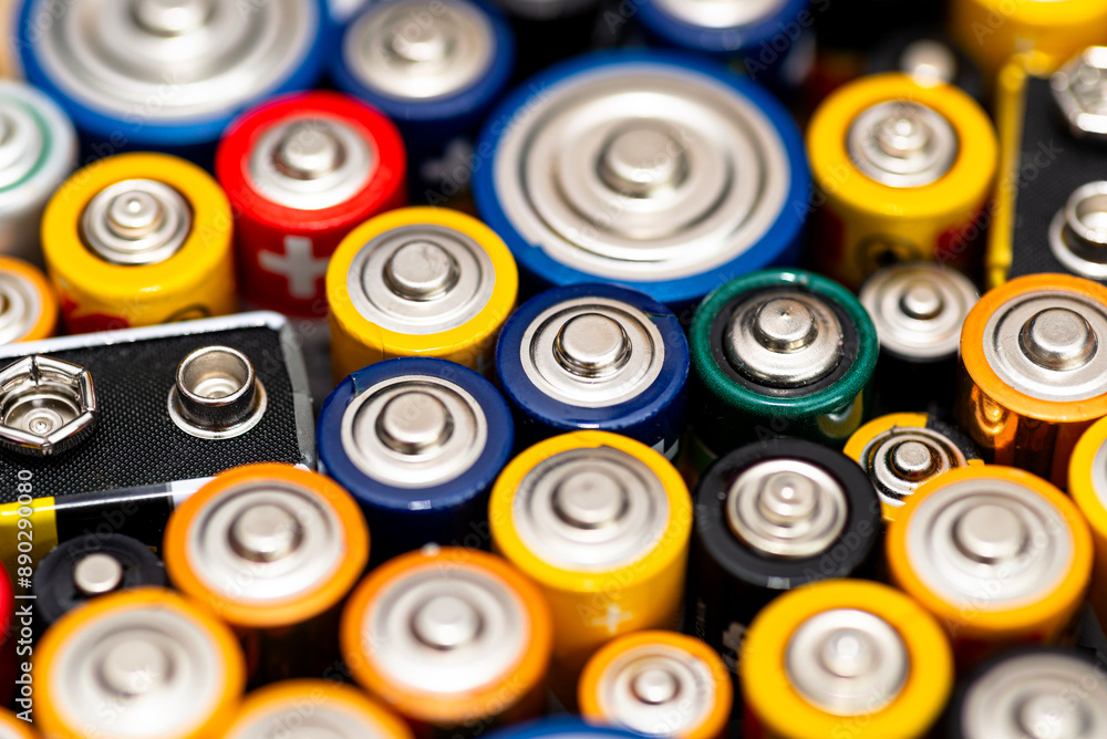 Background made of various alkaline and lithium-ion batteries, positive pole visible. Background made of various alkaline and lithium-ion batteries, positive pole visible.