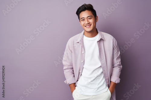 A man in a white shirt and a purple shirt is smiling