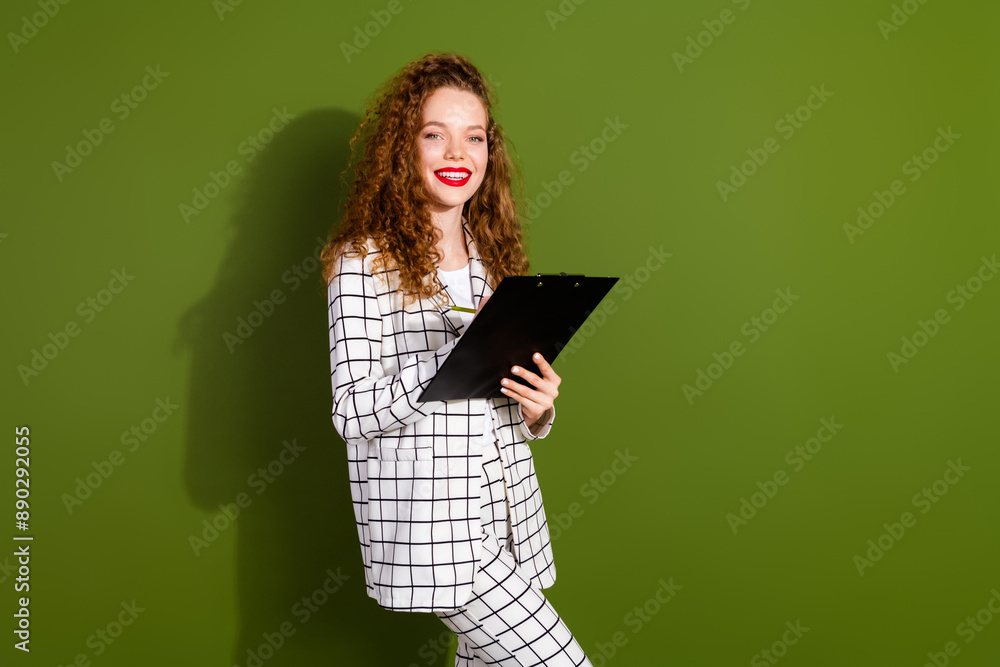 Photo portrait of pretty young girl sign contract paperholder wear trendy white plaid outfit isolated on khaki color background Photo portrait of pretty young girl sign contract paperholder wear trendy white plaid outfit isolated on khaki color background