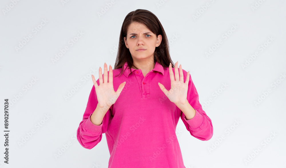 Portrait of young woman making stop sign in front of the camera. Portrait of young woman making stop sign in front of the camera.