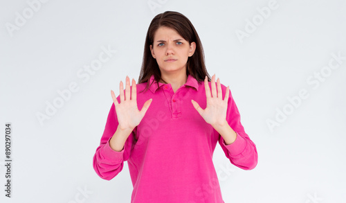 Portrait of young woman making stop sign in front of the camera. © Яна Солодкая