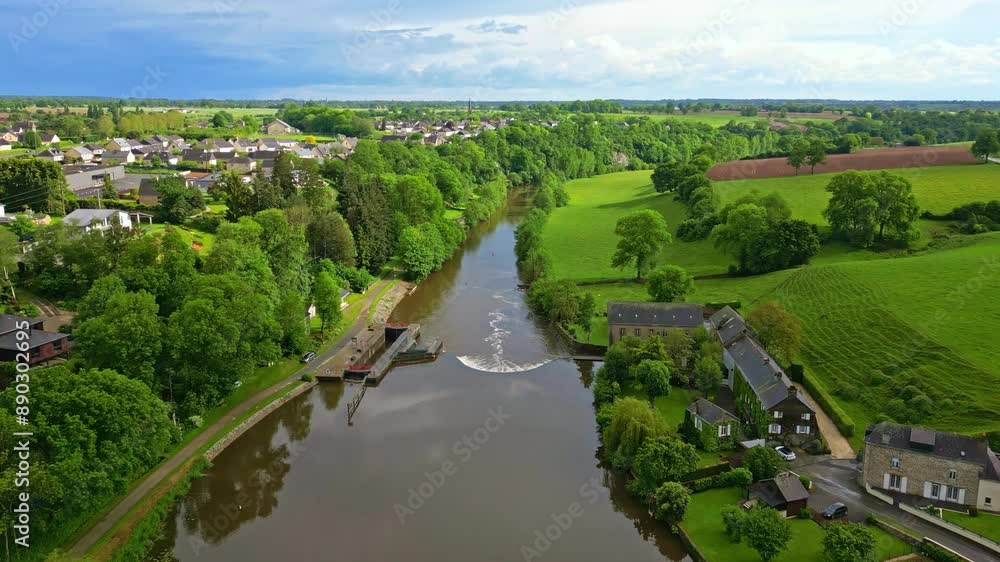 River crossing countryside near Saint-Baudelle and Saint-Baudelle lock or weir, Mayenne in France. Aerial forward River crossing countryside near Saint-Baudelle and Saint-Baudelle lock or weir, Mayenne in France. Aerial forward