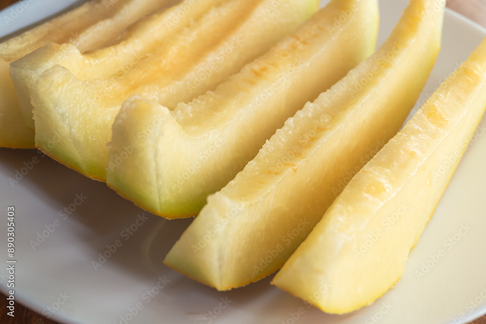 Sliced melon on a plate close-up. Melon slices on a plate Sliced melon on a plate close-up. Melon slices on a plate