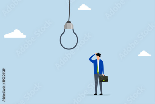 Business risk, skeptical businessman looking at light bulb idea thinking it looks like noose trap.