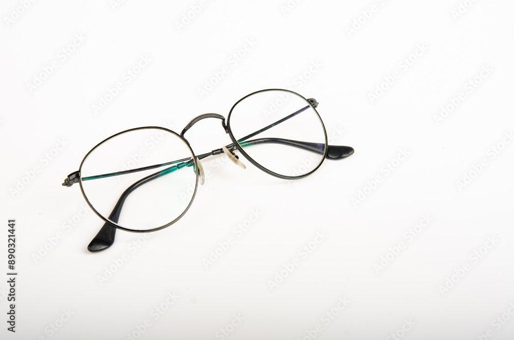 Eyeglasses with round rim for men or women lie diagonally. Eyeglasses with round rim for men or women lie diagonally.