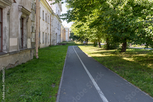 Wallpaper Mural A path in a park with a sidewalk and a row of trees Torontodigital.ca