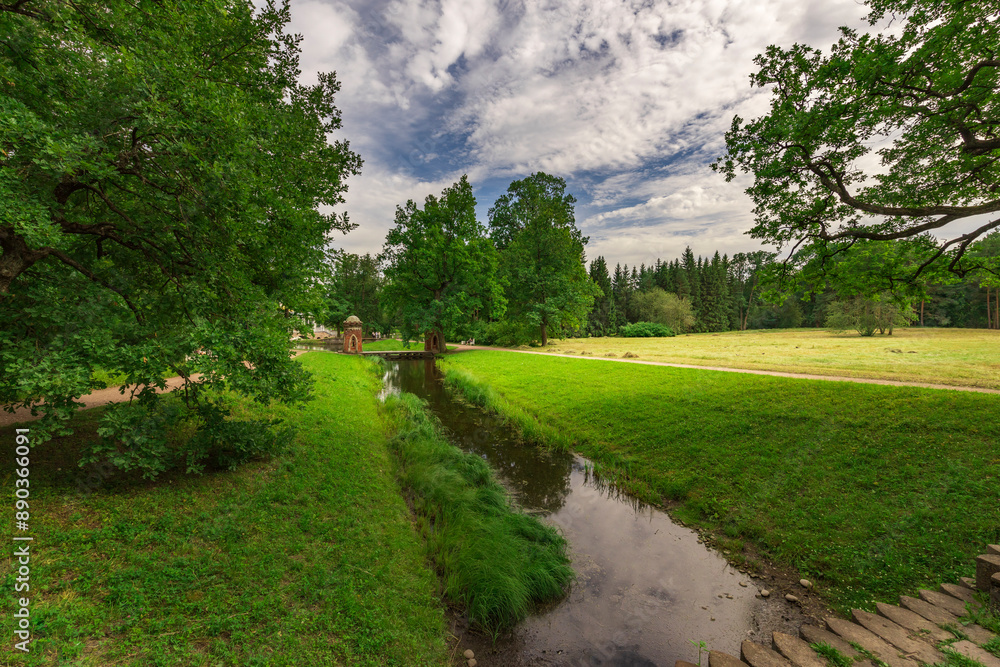 A peaceful scene of a river running through a lush green field A peaceful scene of a river running through a lush green field