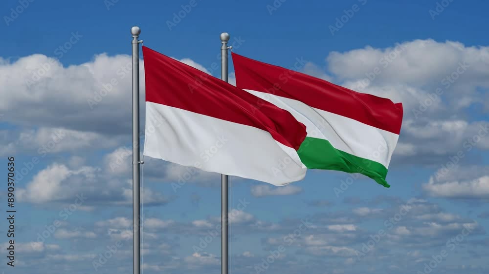 Hungary and Indonesia flags flying together, video concept of the relationship, two country relations concept Hungary and Indonesia flags flying together, video concept of the relationship, two country relations concept