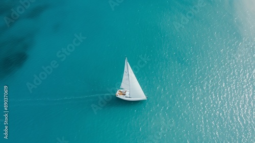 drone capture of a lone sailboat in vast ocean, wake patterns