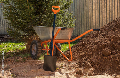 Working with soil, a wheelbarrow for transporting soil and a shovel