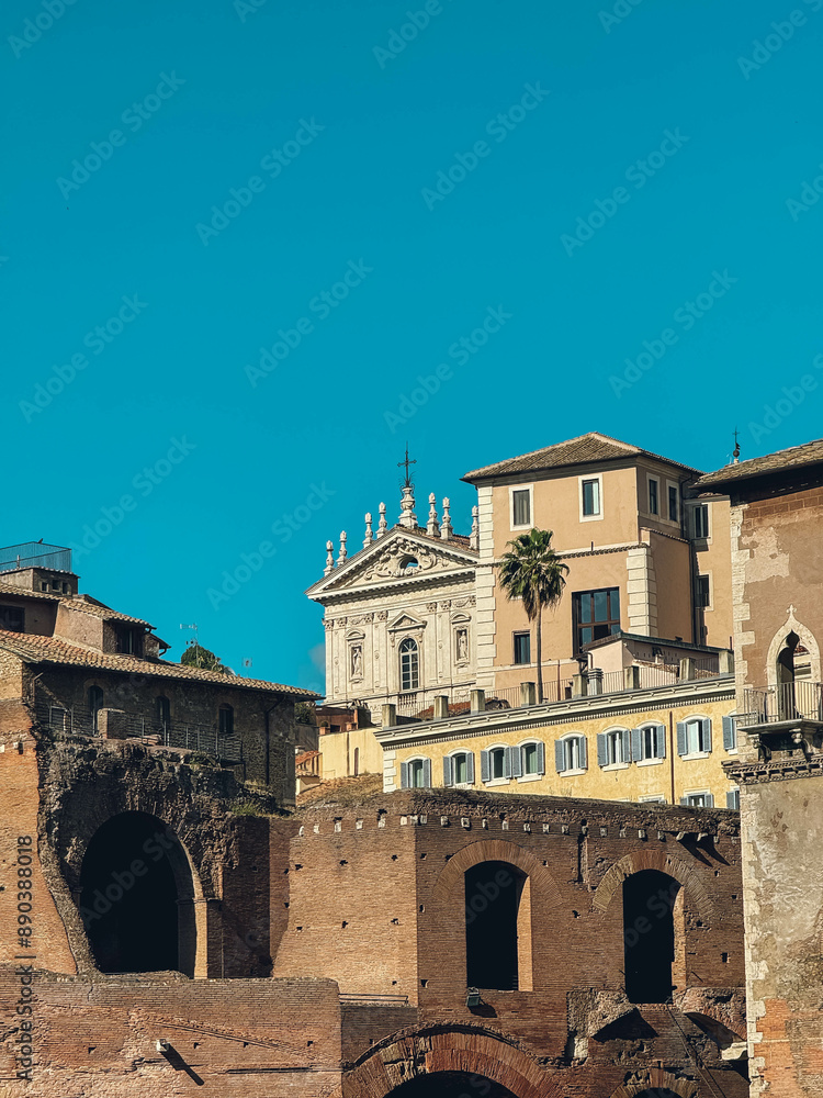A building with a church on top and a palm tree in front. The building is old and has a lot of windows A building with a church on top and a palm tree in front. The building is old and has a lot of windows