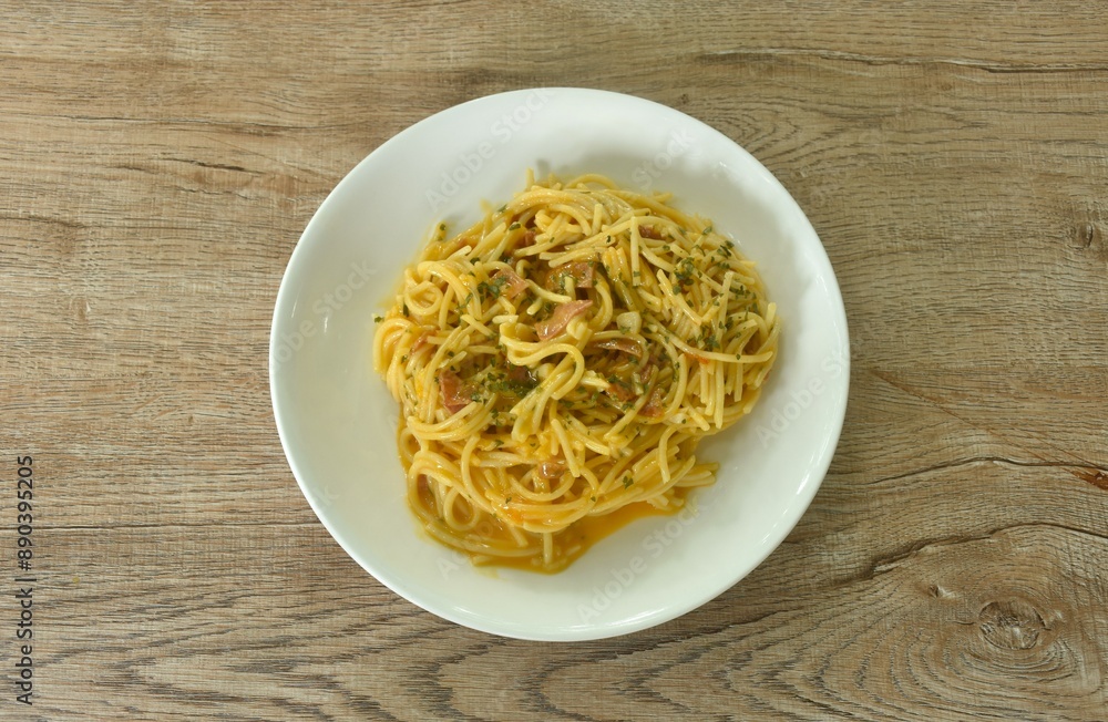 fried spaghetti slice ham pork with chop garlic in carbonara cheese cream sauce on plate   
