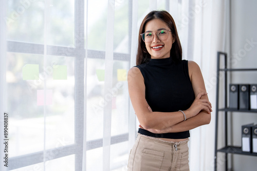 A woman in a black shirt and tan pants is smiling and posing for a picture Free Download A woman in a black shirt and tan pants is smiling and posing for a picture - GFXLoad