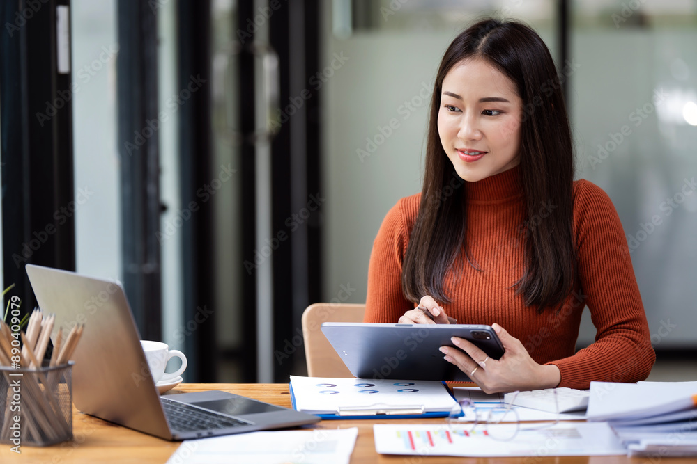 Portrait of confident businesswoman using digital tablet during working in office. Portrait of confident businesswoman using digital tablet during working in office.