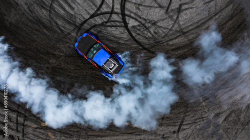 Obraz na płótnie Aerial top view car drifting diffusion race drift car with lots of smoke from burning tires on speed track, Professional driver drifting car with lots of white smoke. w salonie