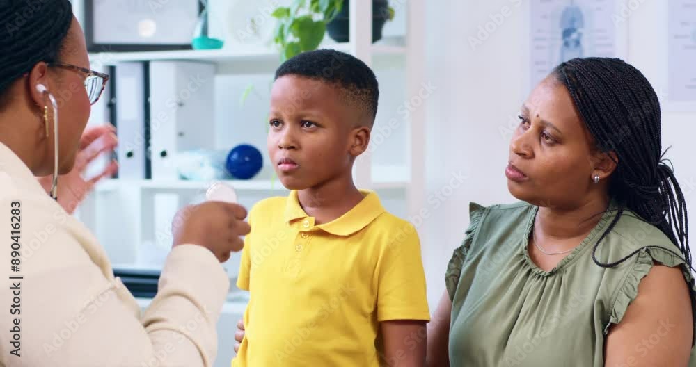 Young Boy In Consultation With Doctor And Mother