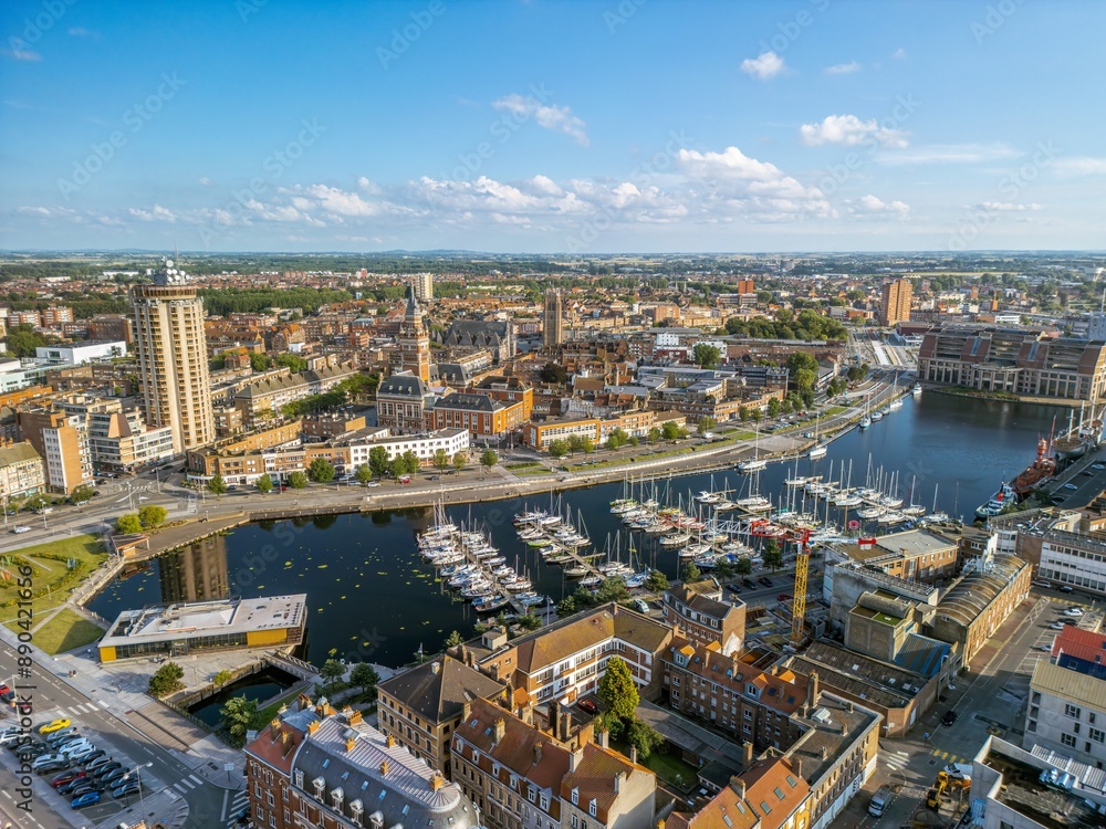 Obraz premium The drone aerial view of Marina Port du Commerce and the tower of the townhall, Dunkirk, France. Dunkirk is a commune in the department of Nord in northern France. 