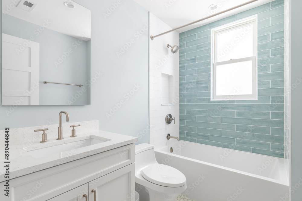 A bathroom with a white vanity cabinet, white marble countertop, and a shower with white and light blue subway tiles. No brands or labels. A bathroom with a white vanity cabinet, white marble countertop, and a shower with white and light blue subway tiles. No brands or labels.