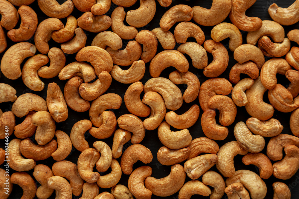 Roasted Organic Cashews on a black background. Roasted Organic Cashews on a black background.