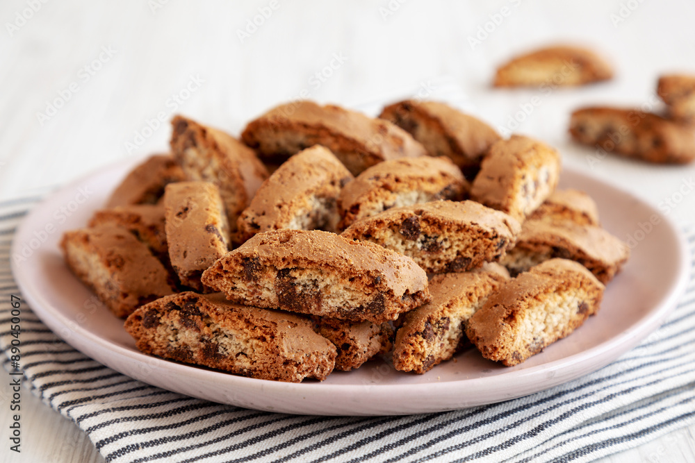 Homemade Cantuccini Cookies with Chocolate Chips on a Plate, low angle view. Homemade Cantuccini Cookies with Chocolate Chips on a Plate, low angle view.