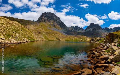 Lakes formed when the snow melted in a spring weather with white clouds in the blue sky. Lakes formed at the summit. Kackar Mountains. Verçenik photo