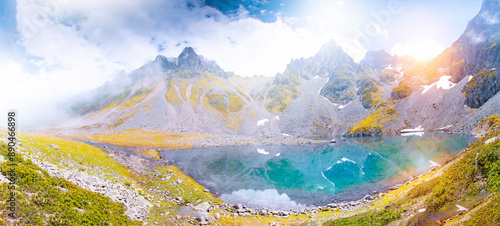 Lakes formed when the snow melted in a spring weather with white clouds in the blue sky. Lakes formed at the summit. Kackar Mountains. Verçenik photo