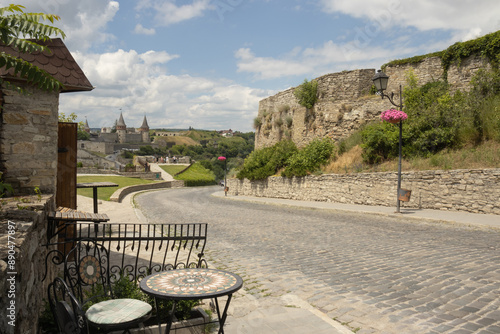 An empty cobblestone road to the Kamianets-Podilskyi Castle in the summer 