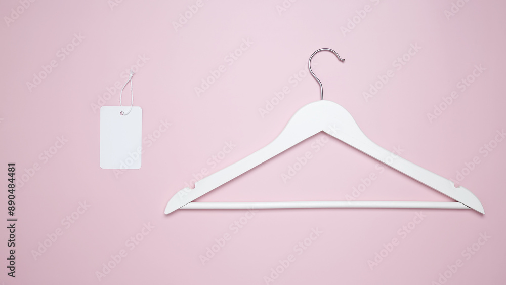 Creative flat lay hangers with white paper label. Clothing tag, label blank mockup template. Sale discount store promo shopping concept. Top view. Copy space Creative flat lay hangers with white paper label. Clothing tag, label blank mockup template. Sale discount store promo shopping concept. Top view. Copy space