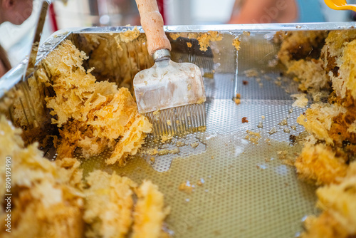 Capping Scratcher and Yellow Beewax in a Metal Decapping Tray photo