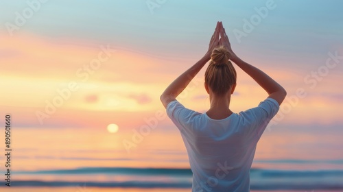 Woman practicing yoga at sunrise on a quiet beach, wellness and relaxation.