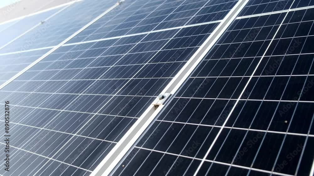 Close-up of the surface of photovoltaic solar panels installed on the roof of a building to produce clean, green electricity. Manufacturing renewable energy concept. Close-up of the surface of photovoltaic solar panels installed on the roof of a building to produce clean, green electricity. Manufacturing renewable energy concept.