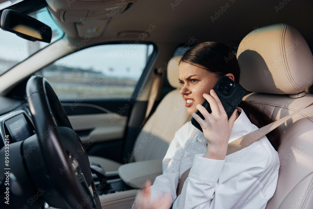 Woman, cell phone, driver, car, steering wheel a woman sits in the driver's seat of a car, holding the steering wheel while talking on a cell phone, illustrating a distracted driving scenario