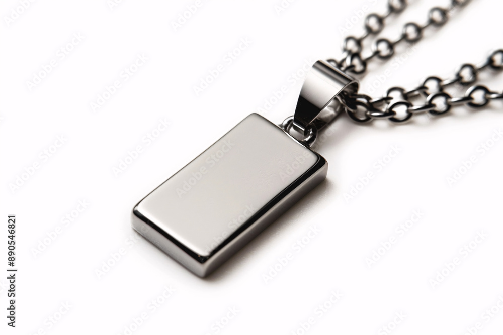 a silver rectangular pendant on a chain a silver rectangular pendant on a chain