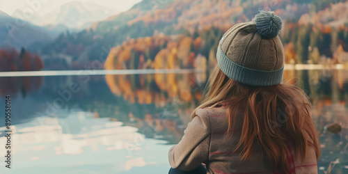 Woman in Beanie Enjoying Scenic Mountain Lake View During Autumn photo