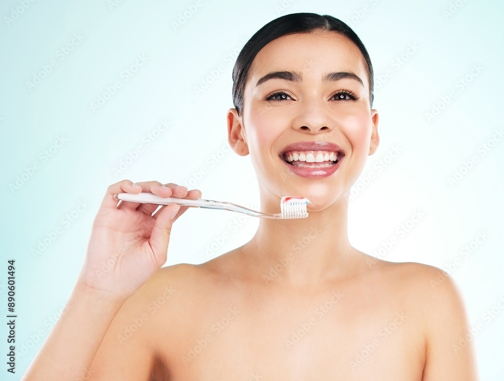 Washing, teeth and smile of woman, toothbrush and routine for hygiene in morning, studio and oral health. Blue background, toothpaste and cleaning of tooth, bacteria and dental for mouth and portrait Washing, teeth and smile of woman, toothbrush and routine for hygiene in morning, studio and oral health. Blue background, toothpaste and cleaning of tooth, bacteria and dental for mouth and portrait