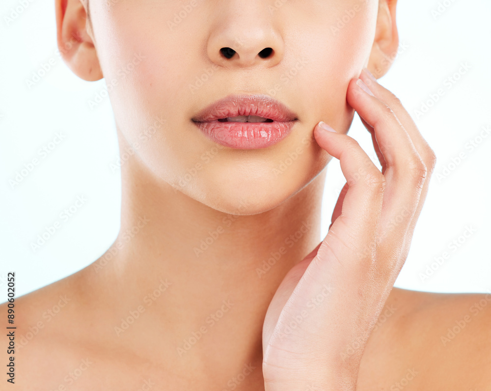 Beauty, natural and mouth of woman in studio on blue background for cosmetics or dermatology. Face, hand and skincare with model touching cheek at spa for collagen, health or wellness treatment Beauty, natural and mouth of woman in studio on blue background for cosmetics or dermatology. Face, hand and skincare with model touching cheek at spa for collagen, health or wellness treatment