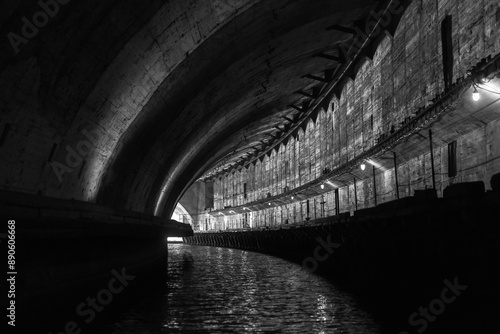 Turning concrete tunnel. Abandoned underground submarine base © evannovostro