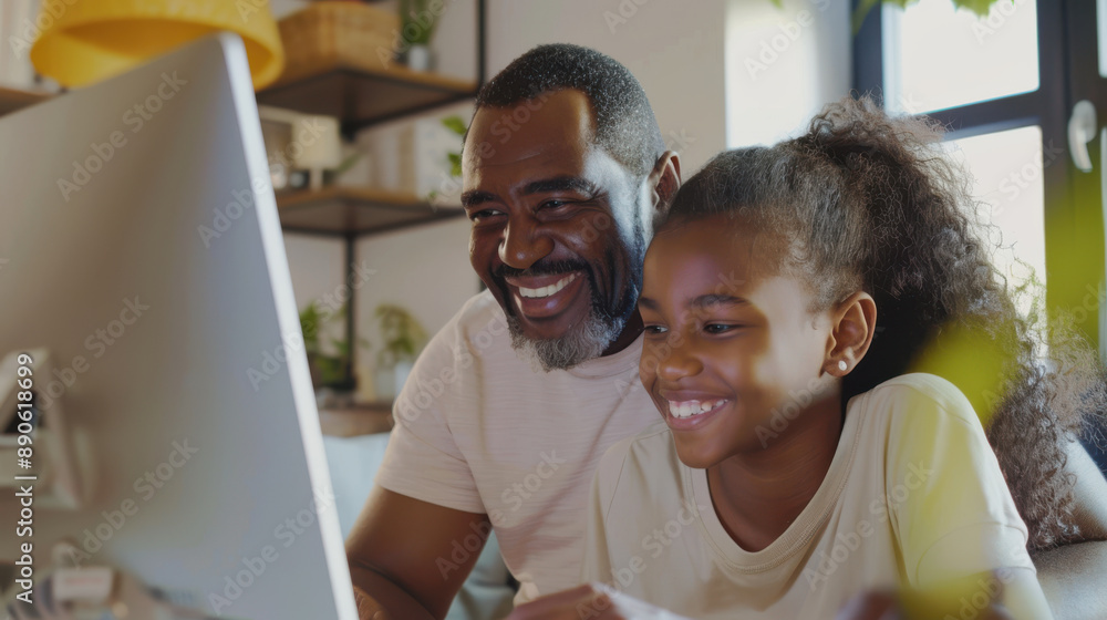 A dedicated father teaching his happy teenage daughter at home, both focused on a computer screen while studying A dedicated father teaching his happy teenage daughter at home, both focused on a computer screen while studying