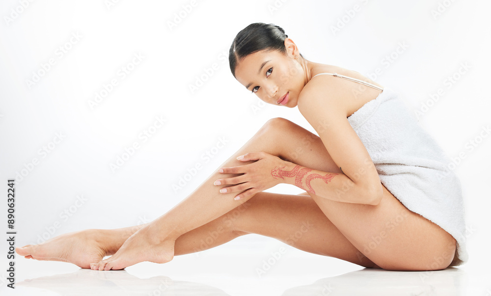 Portrait, hair removal and woman on floor in studio for grooming, organic treatment or morning routine on white background. Legs, body and model with towel for skincare, cosmetic or shine mockup Portrait, hair removal and woman on floor in studio for grooming, organic treatment or morning routine on white background. Legs, body and model with towel for skincare, cosmetic or shine mockup