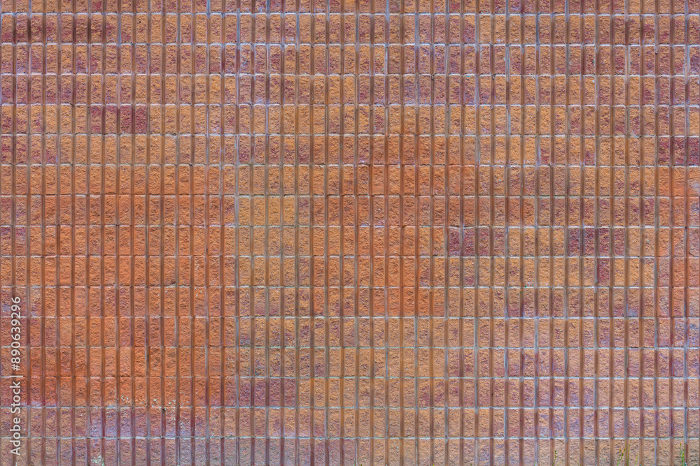 An abstract image of the texture on a faded and worn exterior red brick wall. An abstract image of the texture on a faded and worn exterior red brick wall.
