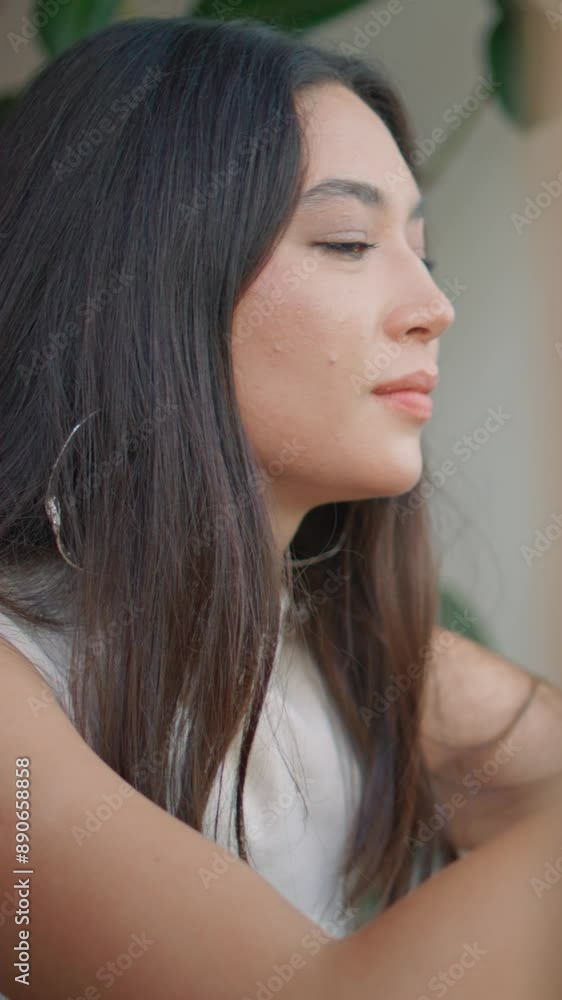 Attractive brunette browsing mobile phone application in cafe close up vertical Attractive brunette browsing mobile phone application in cafe close up vertical