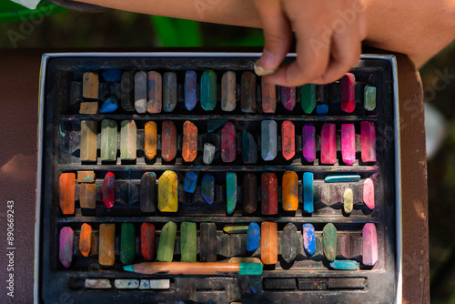 Set of colored pastel paint crayons on chair outdoors photo